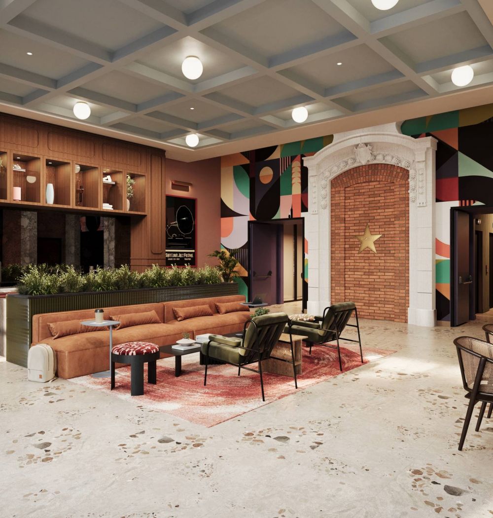 LOCAL On Delmar apartments Modern lounge with a brown sofa, chairs, plants, and colorful wall art in a spacious, stylish room.