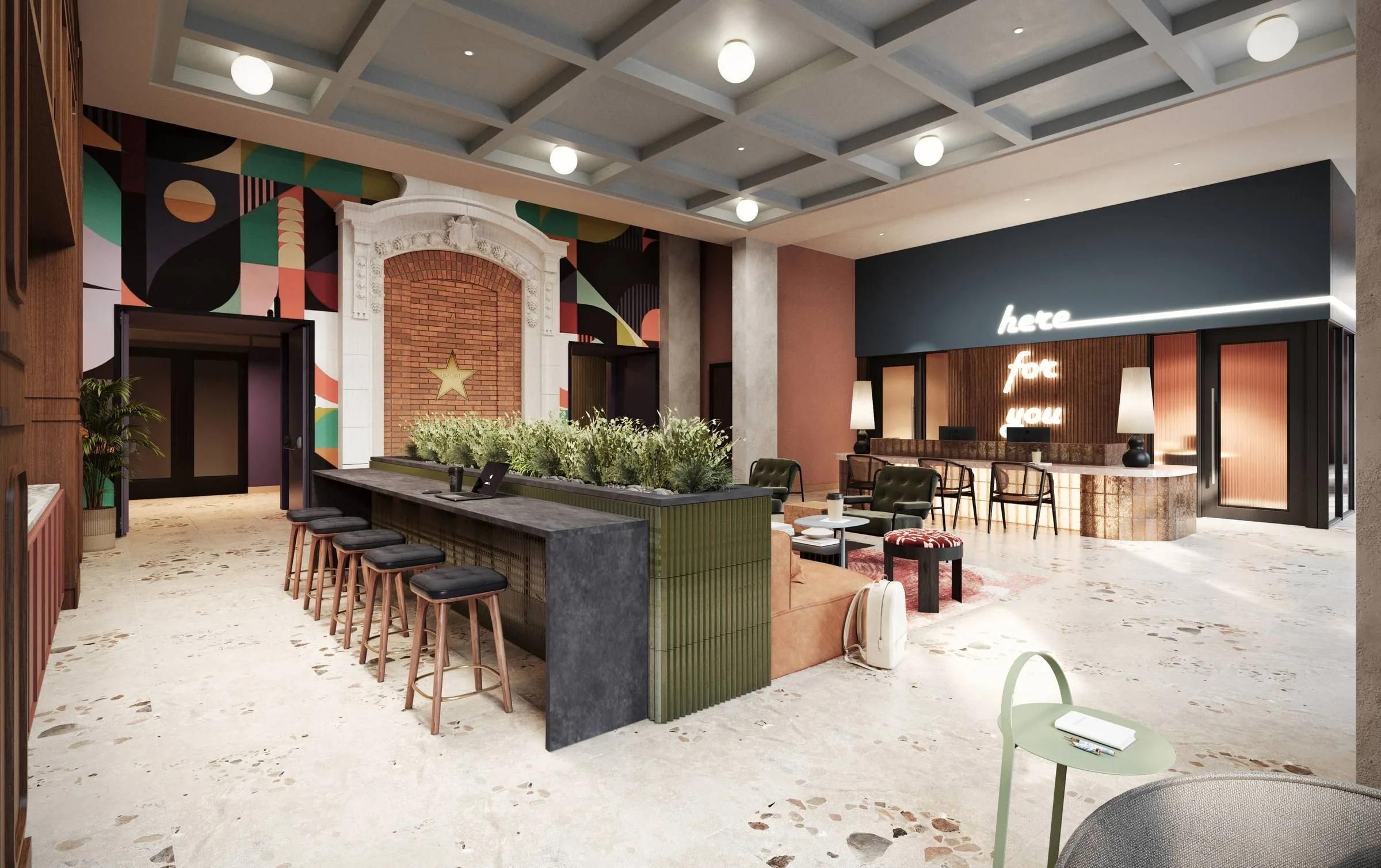 Modern hotel lobby with a central bar, eclectic decor, abstract mural, and a neon "here for you" sign.