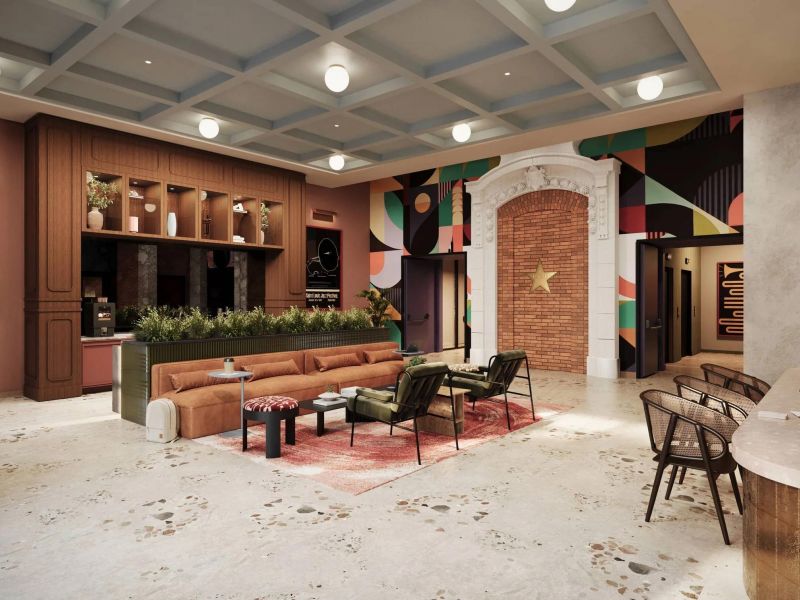 Salón moderno con un sofá marrón, sillones, zona de cocina, cuadros abstractos en las paredes y un arco decorativo de ladrillo.