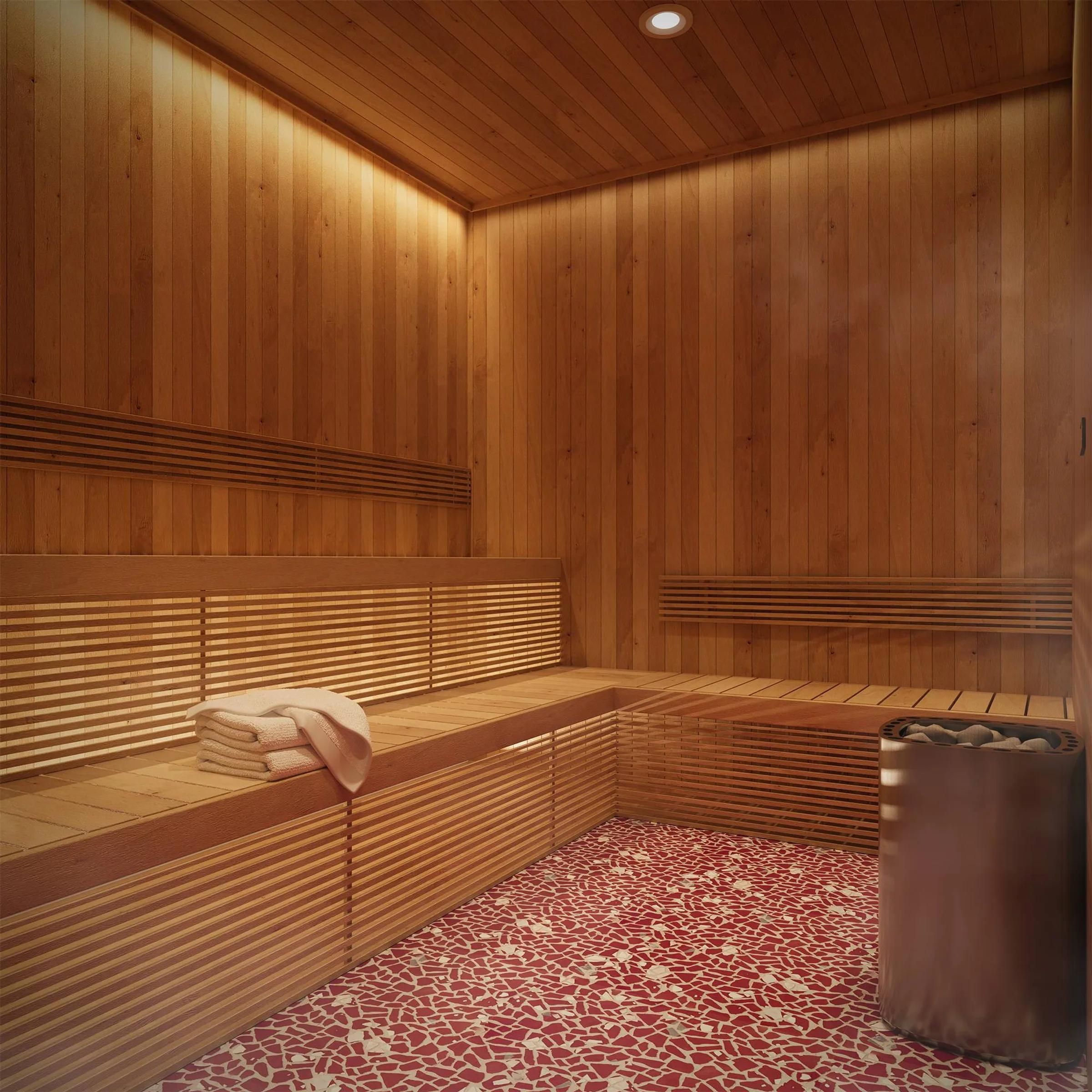 Wooden sauna room with benches, folded towels, and a heater on a red and white tiled floor.